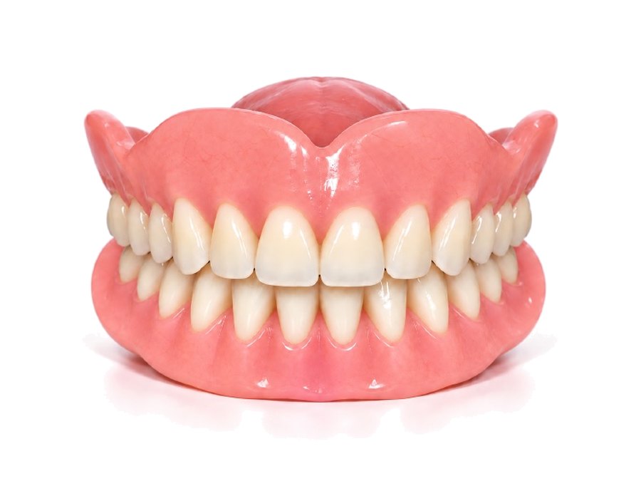 A full denture, upper and lower together: an evenly toned pink gum with a neat set of off-white teeth.